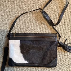 Genuine black and white cowhide shoulder bag designed by Deborah Dumont.